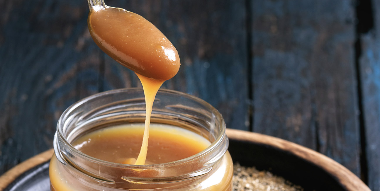 caramel sauce dripping from spoon